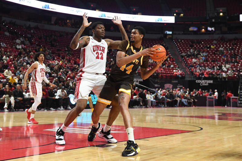 Feb 3, 2024; Las Vegas, Nevada, USA; UNLV Rebels forward Karl Jones (22) defends against Wyoming Cowboys forward Caden Powell (44) in the second half at Thomas & Mack Center. Mandatory Credit: Candice Ward-USA TODAY Sports