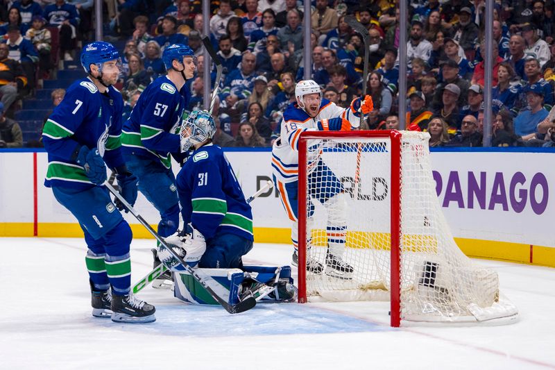 May 8, 2024; Vancouver, British Columbia, CAN; Vancouver Canucks defenseman Carson Soucy (7) and defenseman Tyler Myers (57) and goalie Arturs Silvos (31) react as Edmonton Oilers forward Zach Hyman (18) celebrates his goal during the second period in game one of the second round of the 2024 Stanley Cup Playoffs at Rogers Arena. Mandatory Credit: Bob Frid-USA TODAY Sports