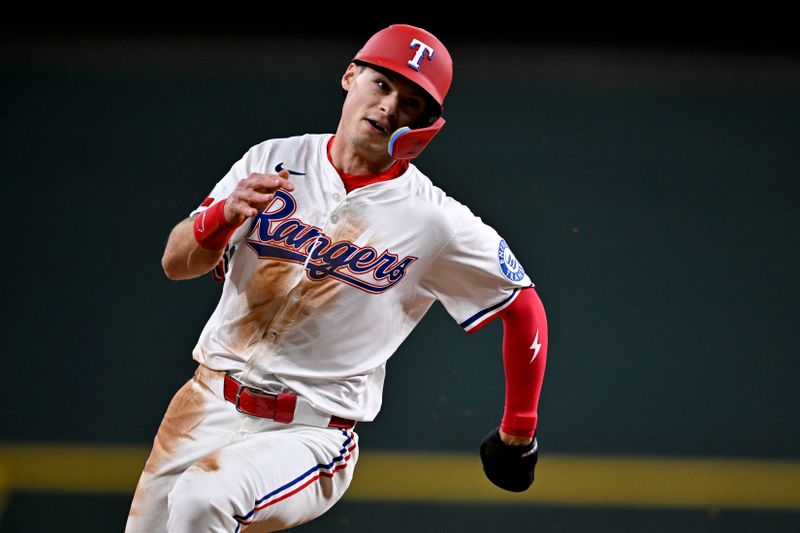 Jun 30, 2025; Arlington, Texas, USA; Texas Rangers center fielder Michael Helman (24) scores from second base during the seventh inning against the Baltimore Orioles at Globe Life Field. Mandatory Credit: Jerome Miron-Imagn Images