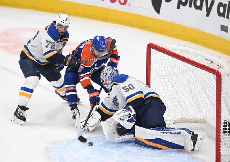 Apr 9, 2025; Edmonton, Alberta, CAN; St. Louis Blues defenseman Justin Faulk (72) checks Edmonton Oilers right wing Connor Brown (28) in front of Blues goalie Jordan Binnington (50) during the first period at Rogers Place. Mandatory Credit: Walter Tychnowicz-Imagn Images