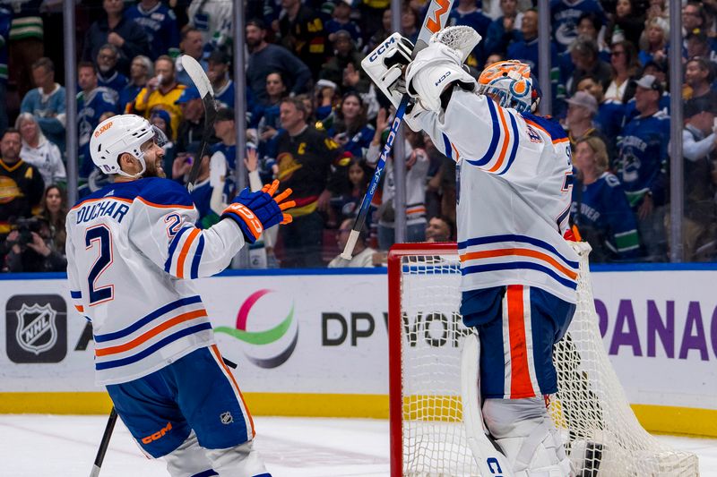 May 20, 2024; Vancouver, British Columbia, CAN; Edmonton Oilers defenseman Evan Bouchard (2) and goalie Stuart Skinner (74) celebrate their victory over the Vancouver Canucks in game seven of the second round of the 2024 Stanley Cup Playoffs at Rogers Arena. Mandatory Credit: Bob Frid-USA TODAY Sports