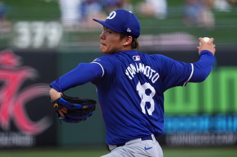 Feb 28, 2024; Surprise, Arizona, USA; Los Angeles Dodgers starting pitcher Yoshinobu Yamamoto (18) pitches during the third inning against the Texas Rangers at Surprise Stadium. Mandatory Credit: Joe Camporeale-USA TODAY Sports