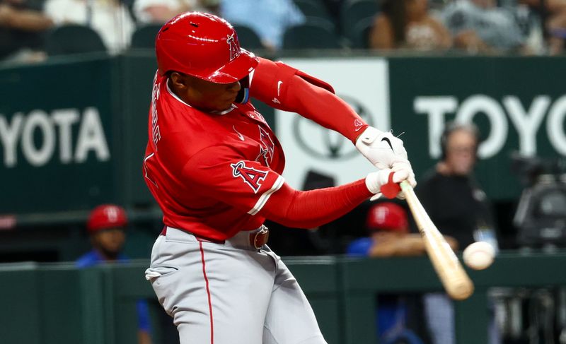 Aug 27, 2025; Arlington, Texas, USA;  Los Angeles Angels second baseman Christian Moore (4) hits a home run during the fifth inning against the Texas Rangers at Globe Life Field. Mandatory Credit: Kevin Jairaj-Imagn Images