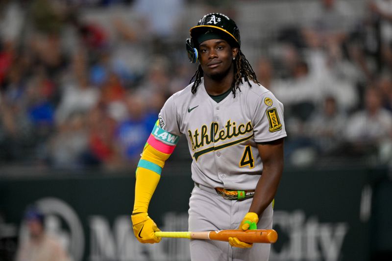 May 1, 2025; Arlington, Texas, USA; Athletics right fielder Lawrence Butler (4) walks off the field after he strikes out against the Texas Rangers during the seventh inning at Globe Life Field. Mandatory Credit: Jerome Miron-Imagn Images