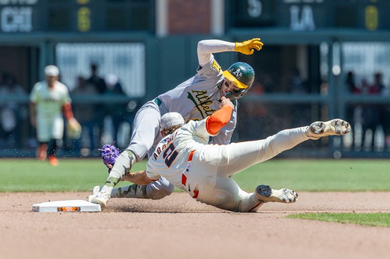 May 18, 2025; San Francisco, California, USA; San Francisco Giants shortstop Willy Adames (2) attempts to tag Oakland Athletics shortstop Jacob Wilson (5) during the seventh inning at Oracle Park. Mandatory Credit: Bob Kupbens-Imagn Images
