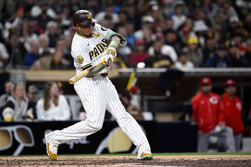 Apr 30, 2024; San Diego, California, USA; San Diego Padres designated hitter Manny Machado (13) hits a three-RBI double during the fifth inning against the Cincinnati Reds at Petco Park. Mandatory Credit: Orlando Ramirez-USA TODAY Sports