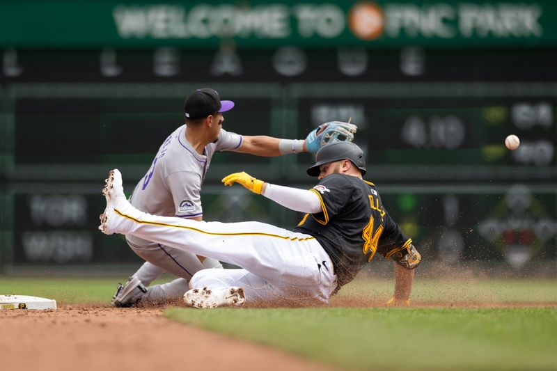 May 5, 2024; Pittsburgh, Pennsylvania, USA; Pittsburgh Pirates first baseman Rowdy Tellez (44) slides into second base beating the tag by Colorado Rockies shortstop Alan Trejo (13) for a double during the seventh inning at PNC Park. Mandatory Credit: Scott Galvin-USA TODAY Sports