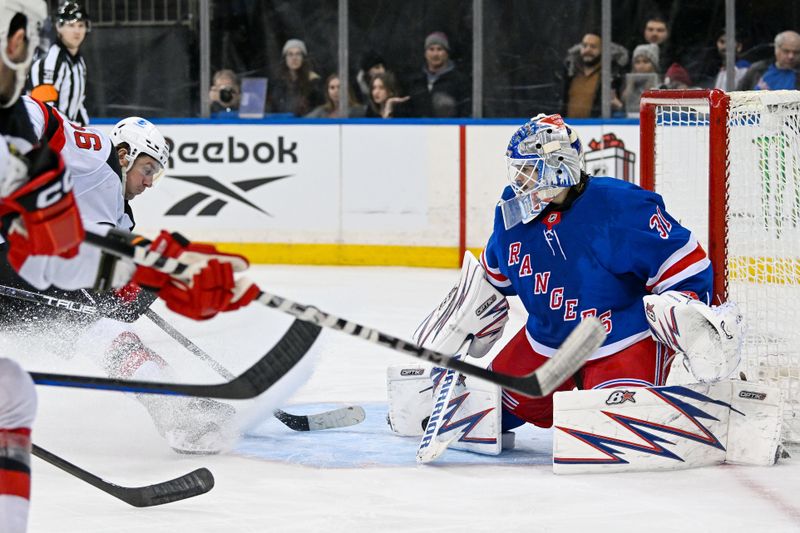 Dec 2, 2024; New York, New York, USA;  New York Rangers goaltender Igor Shesterkin (31) makes a save against New Jersey Devils center Jack Hughes (86) during the third period at Madison Square Garden. Mandatory Credit: Dennis Schneidler-Imagn Images