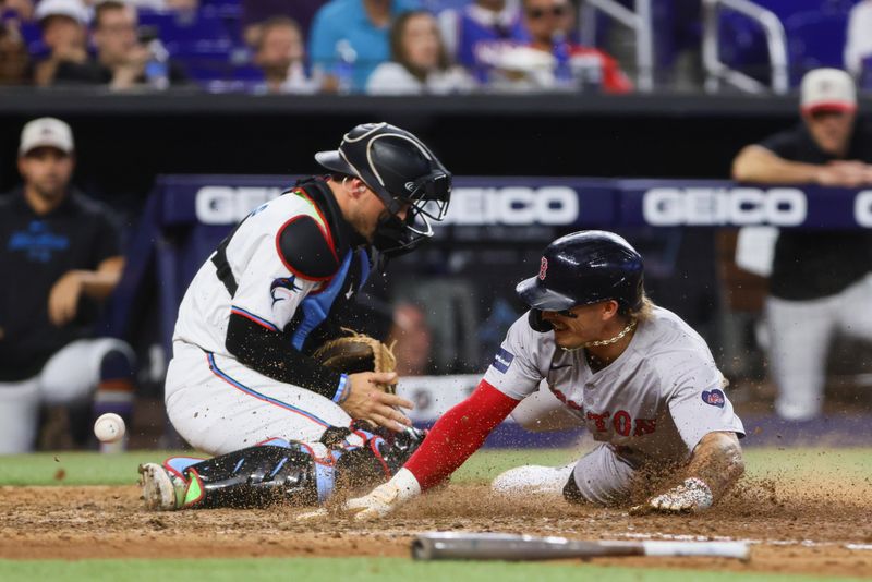 Jul 4, 2024; Miami, Florida, USA; Boston Red Sox left fielder Jarren Duran (16) slides at home plate and scores against the Miami Marlins during the eleventh inning at loanDepot Park. Mandatory Credit: Sam Navarro-USA TODAY Sports