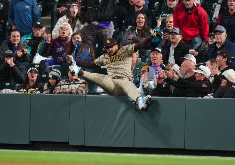 Apr 23, 2024; Denver, Colorado, USA; San Diego Padres outfielder Fernando Tatis Jr. (23) is unable to field a ball in the fifth inning against the Colorado Rockies at Coors Field. Mandatory Credit: Ron Chenoy-USA TODAY Sports