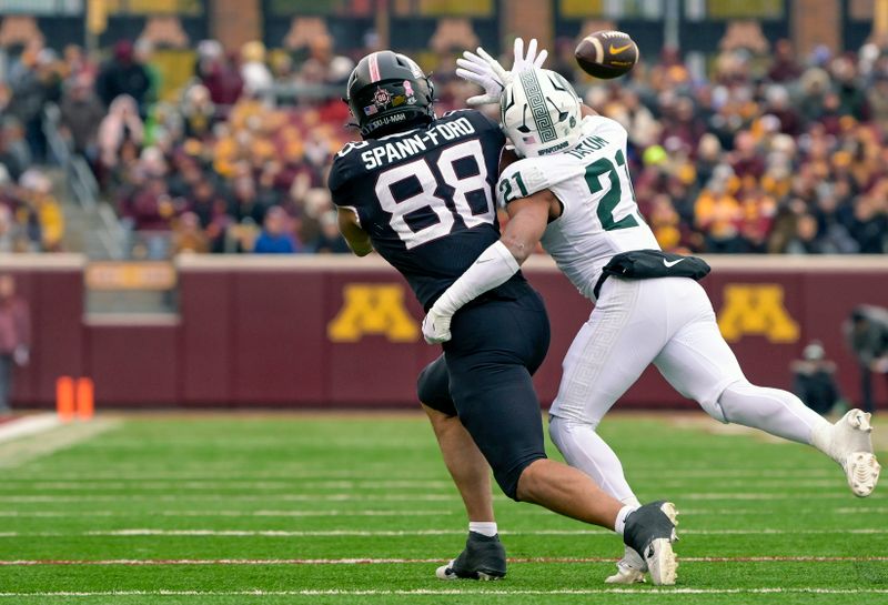 Oct 28, 2023; Minneapolis, Minnesota, USA; Michigan State Spartans defensive back Dillon Tatum (21) is called for pass interference on this play against Minnesota Golden Gophers tight end Brevyn Spann-Ford (88) during the second quarter at Huntington Bank Stadium. Mandatory Credit: Nick Wosika-USA TODAY Sports