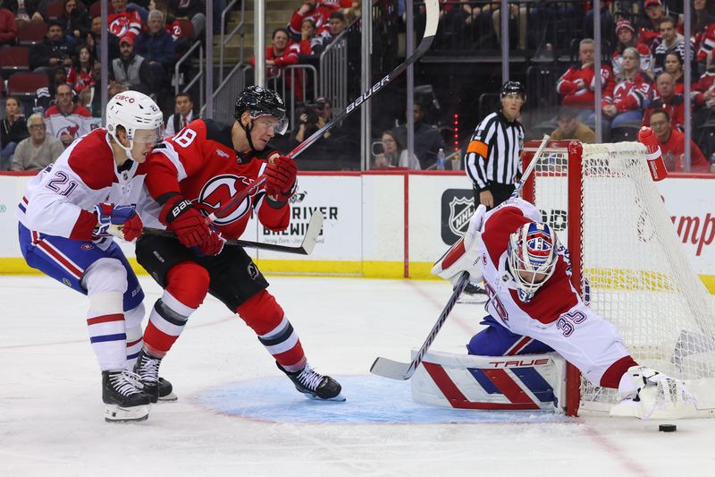 Nov 7, 2024; Newark, New Jersey, USA; Montreal Canadiens goaltender Sam Montembeault (35) covers the puck while defenseman Kaiden Guhle (21) and New Jersey Devils left wing Ondrej Palat (18) battle in front during the second period at Prudential Center. Mandatory Credit: Ed Mulholland-Imagn Images