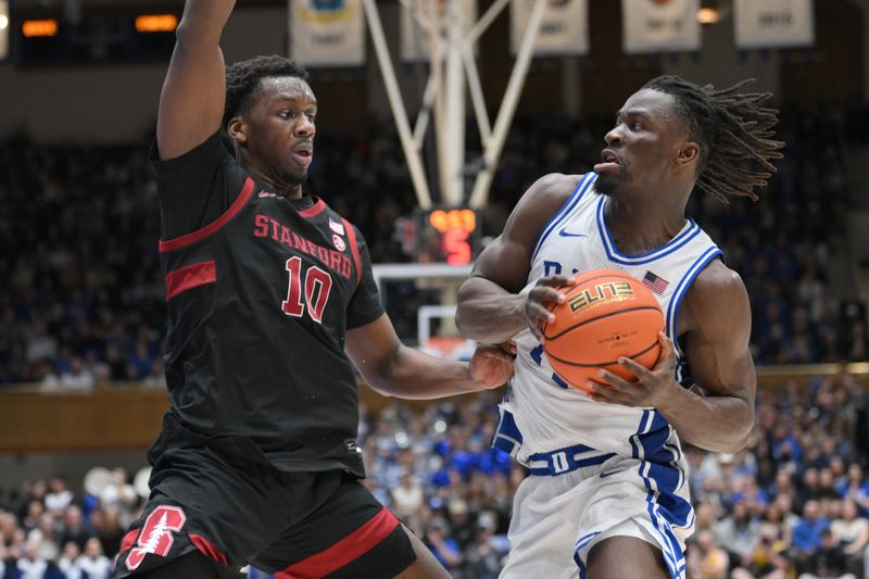 Feb 15, 2025; Durham, North Carolina, USA;  Duke Blue Devils guard Sion James (14) brings the ball around Stanford Cardinal forward Chisom Okpara (10) during the second half at Cameron Indoor Stadium. Blue Devils won 106-70.  Mandatory Credit: Zachary Taft-Imagn Images