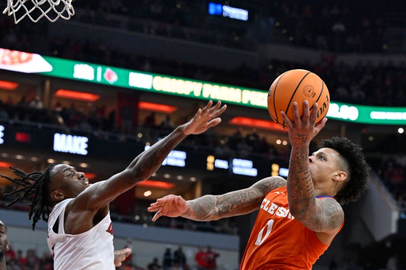 Feb 18, 2023; Louisville, Kentucky, USA;  Clemson Tigers guard Brevin Galloway (11) shoots against Louisville Cardinals guard Mike James (1) during the first half at KFC Yum! Center. Mandatory Credit: Jamie Rhodes-USA TODAY Sports