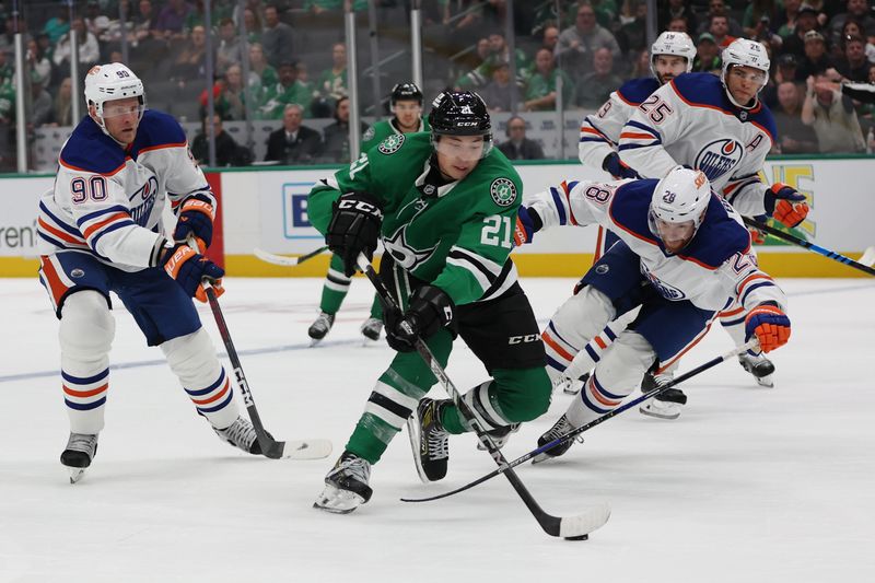 Oct 19, 2024; Dallas, Texas, USA; Dallas Stars left wing Jason Robertson (21) controls the puck against Edmonton Oilers right wing Connor Brown (28) in the third period at American Airlines Center. Mandatory Credit: Tim Heitman-Imagn Images