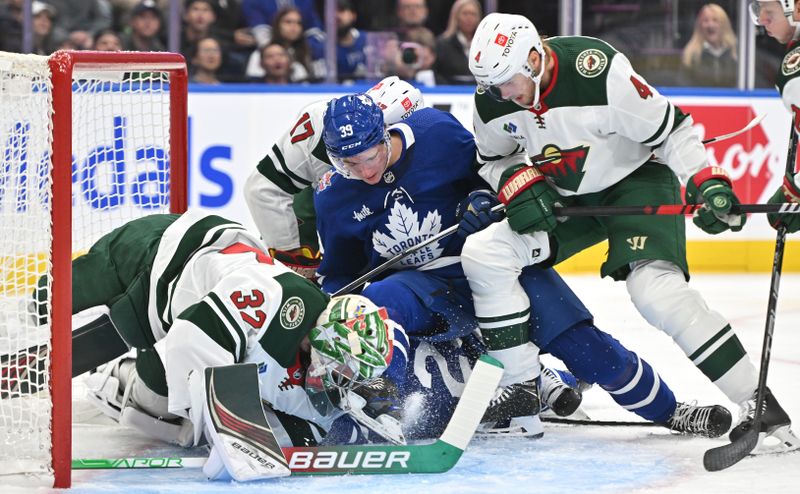 Oct 14, 2023; Toronto, Ontario, CAN;  Minnesota Wild goalie Filip Gustavsson (32) makes a save against Toronto Maple Leafs forward Fraser Minten (39) in the first period at Scotiabank Arena. Mandatory Credit: Dan Hamilton-USA TODAY Sports