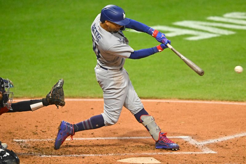 Aug 23, 2023; Cleveland, Ohio, USA; Los Angeles Dodgers right fielder Mookie Betts (50) singles in the second inning against the Cleveland Guardians at Progressive Field. Mandatory Credit: David Richard-USA TODAY Sports