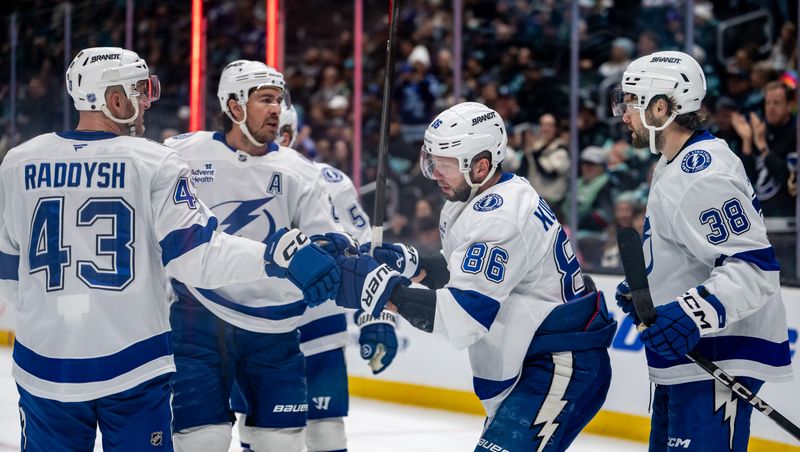 Mar 17, 2026; Seattle, Washington, USA; Tampa Bay Lightning, from left, defenseman Darren Raddysh (43), defenseman Ryan McDonagh (27), forward Nikita Kucherov (86) and forward Brandon Hagel (38) celebrate a goal during the first period against the Seattle Kraken at Climate Pledge Arena. Mandatory Credit: Stephen Brashear-Imagn Images