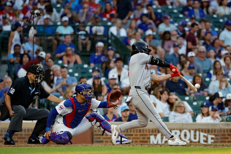 Jul 20, 2024; Chicago, Illinois, USA; Arizona Diamondbacks outfielder Alek Thomas (5) hits a solo home run against the Chicago Cubs during the fifth inning at Wrigley Field. Mandatory Credit: Kamil Krzaczynski-USA TODAY Sports