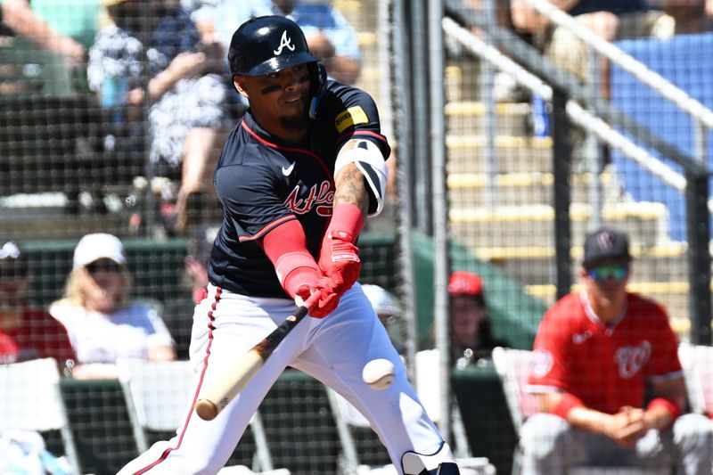 Mar 14, 2025; North Port, Florida, USA; Atlanta Braves shortstop Orlando Arcia (11) hits a single  in the second  inning against the Washington Nationals during spring training at CoolToday Park. Mandatory Credit: Jonathan Dyer-Imagn Images