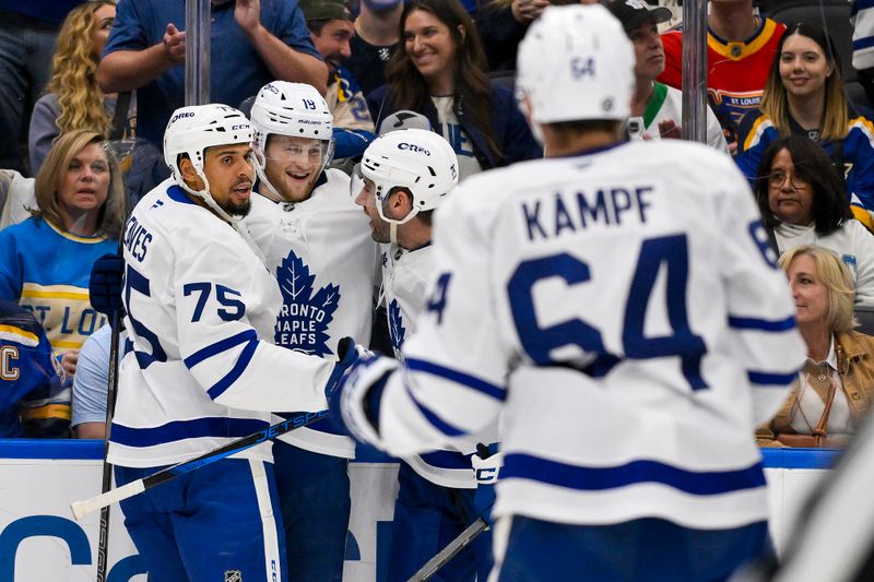 Nov 2, 2024; St. Louis, Missouri, USA;  Toronto Maple Leafs center Steven Lorentz (18) is congratulated by right wing Ryan Reaves (75) and defenseman Conor Timmins (25) after scoring against the St. Louis Blues during the third period at Enterprise Center. Mandatory Credit: Jeff Curry-Imagn Images