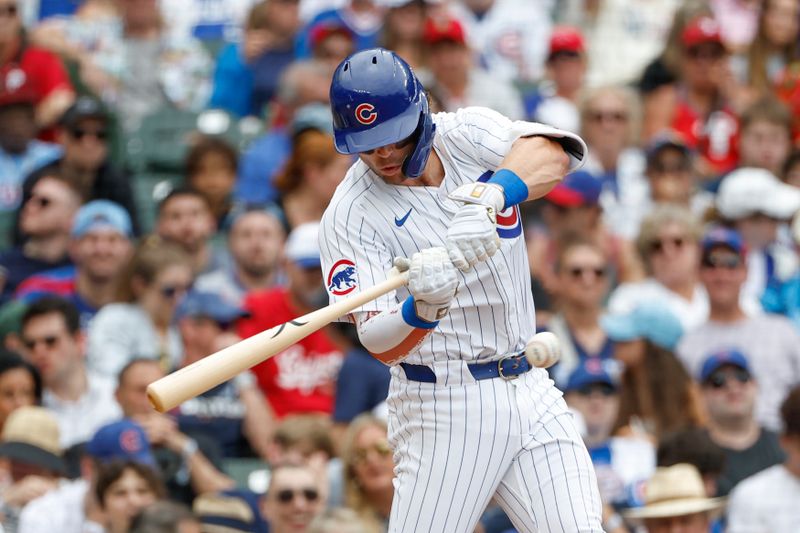 Jul 4, 2024; Chicago, Illinois, USA; Chicago Cubs second baseman Nico Hoerner (2) hits an RBI-single against the Philadelphia Phillies during the fourth inning at Wrigley Field. Mandatory Credit: Kamil Krzaczynski-USA TODAY Sports