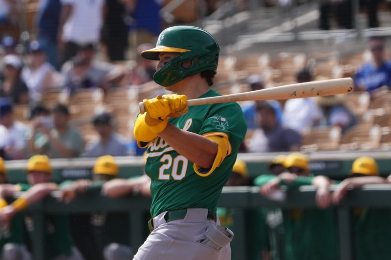 Feb 25, 2024; Phoenix, Arizona, USA; Oakland Athletics designated hitter Zack Gelof (20) bats against the Los Angeles Dodgers during the first inning at Camelback Ranch-Glendale. Mandatory Credit: Joe Camporeale-USA TODAY Sports