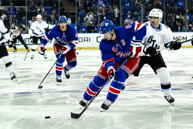 Oct 12, 2024; New York, New York, USA; New York Rangers defenseman Jacob Trouba (8) skates with the puck against Utah Hockey Club center Alex Kerfoot (15) during the third period at Madison Square Garden. Mandatory Credit: John Jones-Imagn Images