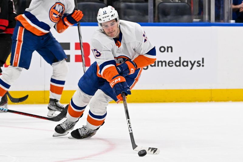 Mar 19, 2024; Elmont, New York, USA; New York Islanders center Mathew Barzal (13) attempts to control the puck against the Carolina Hurricanes during the second period at UBS Arena. Mandatory Credit: Dennis Schneidler-USA TODAY Sports