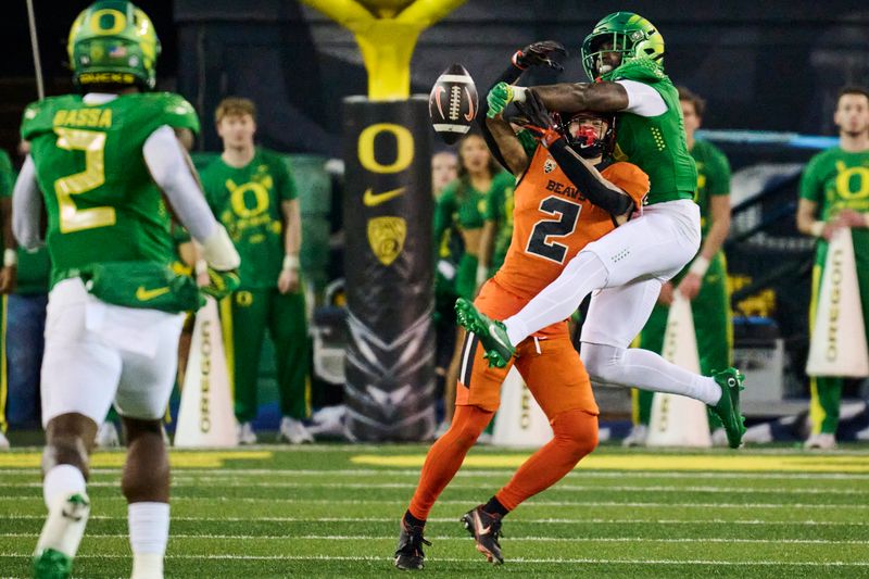 Nov 24, 2023; Eugene, Oregon, USA; Oregon Ducks defensive back Dontae Manning (8) breaks up a pass play during the first half intended for Oregon State Beavers wide receiver Anthony Gould (2 at Autzen Stadium. Mandatory Credit: Troy Wayrynen-USA TODAY Sports