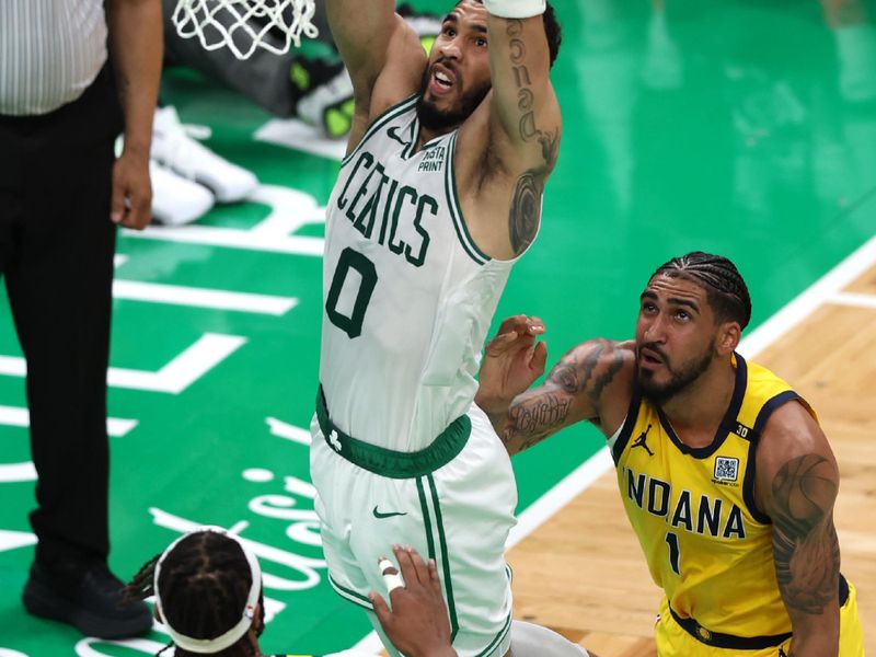 BOSTON, MASSACHUSETTS - MAY 21: Jayson Tatum #0 of the Boston Celtics dunks the ball against Myles Turner #33and Obi Toppin #1 of the Indiana Pacers during the second quarter in Game One of the Eastern Conference Finals at TD Garden on May 21, 2024 in Boston, Massachusetts. NOTE TO USER: User expressly acknowledges and agrees that, by downloading and or using this photograph, User is consenting to the terms and conditions of the Getty Images License Agreement. (Photo by Adam Glanzman/Getty Images)