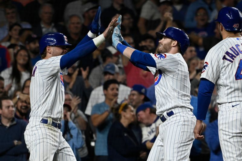 Sep 20, 2023; Chicago, Illinois, USA; Chicago Cubs left fielder Ian Happ (8), right, celebrates his grand slam against the Pittsburgh Pirates with Chicago Cubs second baseman Nico Hoerner (2), left, during the fifth inning at Wrigley Field. Mandatory Credit: Matt Marton-USA TODAY Sports