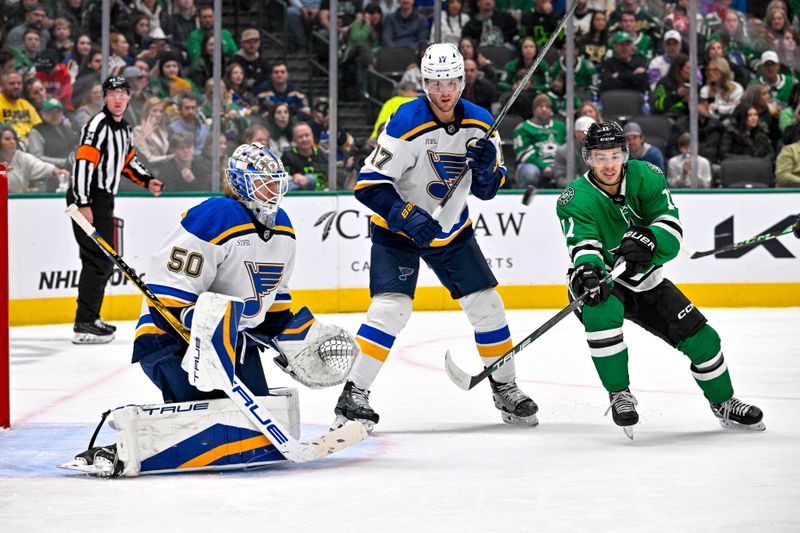 Dec 14, 2024; Dallas, Texas, USA; Dallas Stars center Logan Stankoven (11) attempts to redirect the puck past St. Louis Blues defenseman Cam Fowler (17) and goaltender Jordan Binnington (50) during the second period at American Airlines Center. Mandatory Credit: Jerome Miron-Imagn Images