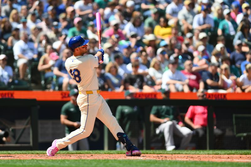 May 12, 2024; Seattle, Washington, USA; Seattle Mariners designated hitter Mitch Garver (18) hits a 2-run home run against the Oakland Athletics during the fifth inning at T-Mobile Park. Mandatory Credit: Steven Bisig-USA TODAY Sports