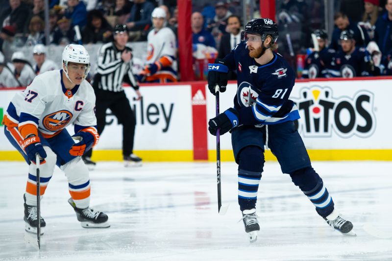 Jan 16, 2024; Winnipeg, Manitoba, CAN; Winnipeg Jets forward Kyle Connor (81) looks to make a pass by New York Islanders forward Anders Lee (27) during the first period at Canada Life Centre. Mandatory Credit: Terrence Lee-USA TODAY Sports