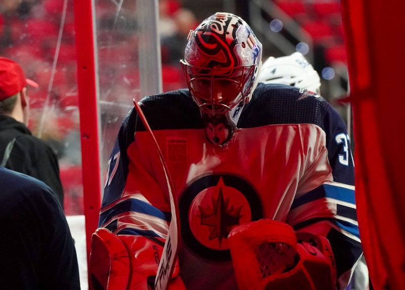 Mar 2, 2024; Raleigh, North Carolina, USA; Winnipeg Jets goaltender Connor Hellebuyck (37) comes off the ice after the warmups before the game against the Carolina Hurricanes at PNC Arena. Mandatory Credit: James Guillory-USA TODAY Sports