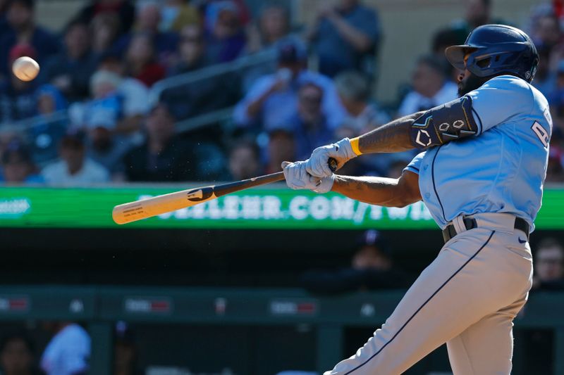 Sep 13, 2023; Minneapolis, Minnesota, USA; Tampa Bay Rays left fielder Randy Arozarena (56) hits a solo home run against the Minnesota Twins in the ninth inning at Target Field. Mandatory Credit: Bruce Kluckhohn-USA TODAY Sports