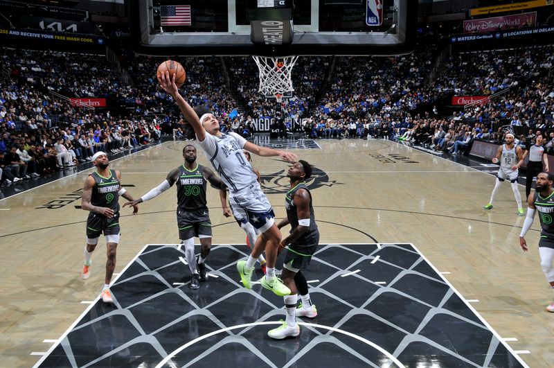 ORLANDO, FL - JANUARY 9: Anthony Black #0 of the Orlando Magic drives to the basket during the game against the Minnesota Timberwolves on January 9, 2025 at Kia Center in Orlando, Florida. NOTE TO USER: User expressly acknowledges and agrees that, by downloading and or using this photograph, User is consenting to the terms and conditions of the Getty Images License Agreement. Mandatory Copyright Notice: Copyright 2025 NBAE (Photo by Fernando Medina/NBAE via Getty Images)