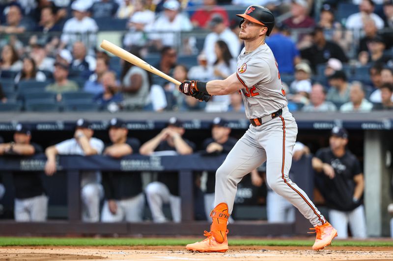 Jun 19, 2024; Bronx, New York, USA;  Baltimore Orioles designated hitter Ryan O'Hearn (32) hits an RBI double in the first inning against the New York Yankees at Yankee Stadium. Mandatory Credit: Wendell Cruz-USA TODAY Sports