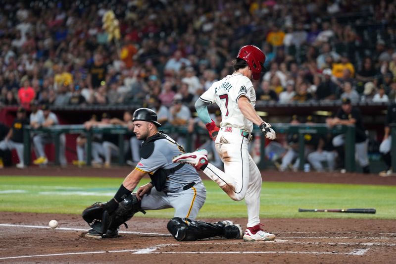 Jul 26, 2024; Phoenix, Arizona, USA; Arizona Diamondbacks outfielder Corbin Carroll (7) beats a throw to Pittsburgh Pirates catcher Joey Bart (14) and scores a run during the third inning at Chase Field. Mandatory Credit: Joe Camporeale-USA TODAY Sports