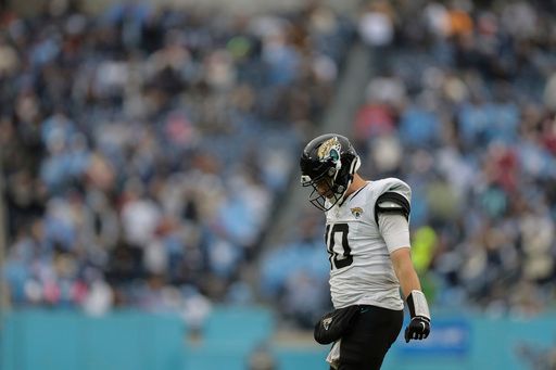 Jacksonville Jaguars quarterback Mac Jones (10) walks off the field during the second half of an NFL football game against the Tennessee Titans, Sunday, Dec. 8, 2024, in Nashville, Tenn. (AP Photo/Stew Milne)