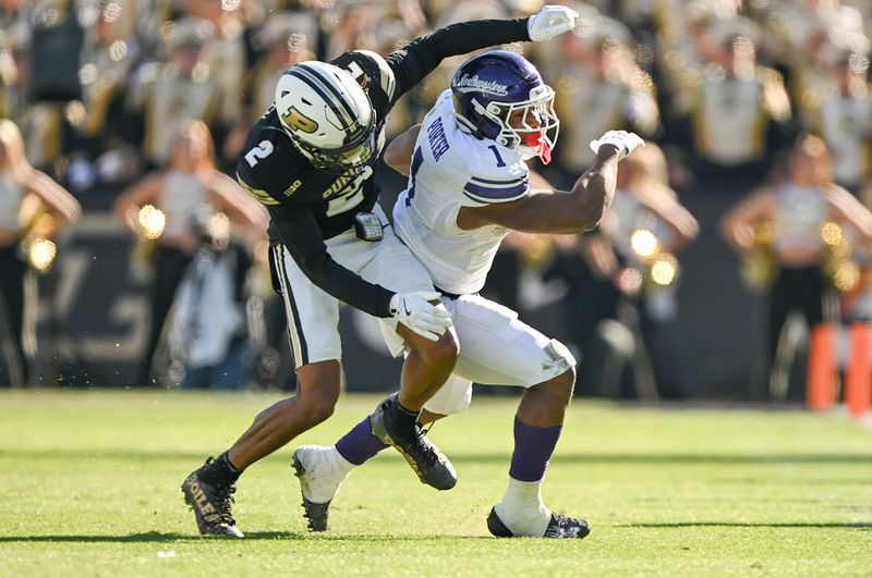 Nov 2, 2024; West Lafayette, Indiana, USA; Purdue Boilermakers defensive back Nyland Green (2) tackles Northwestern Wildcats running back Cam Porter (1) during the second half at Ross-Ade Stadium. Mandatory Credit: Marc Lebryk-Imagn Images