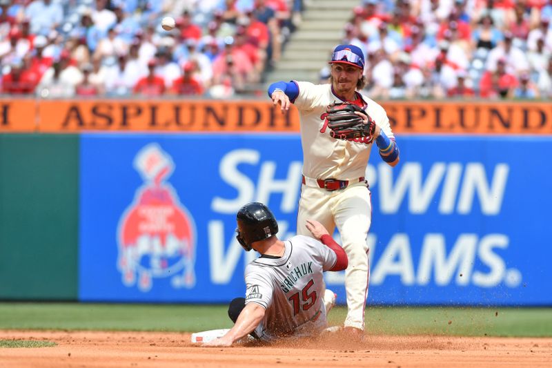 Jun 23, 2024; Philadelphia, Pennsylvania, USA; Philadelphia Phillies second base Bryson Stott (5) gets force out on Arizona Diamondbacks outfielder Randal Grichuk (15) and throws to first base to complete double play during the second inning at Citizens Bank Park. Mandatory Credit: Eric Hartline-USA TODAY Sports