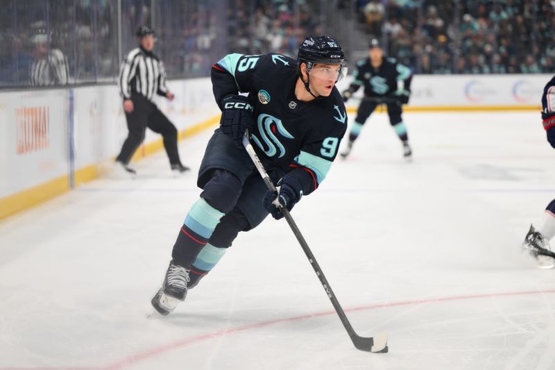 Nov 12, 2024; Seattle, Washington, USA; Seattle Kraken left wing Andre Burakovsky (95) advances the puck against the Columbus Blue Jackets during the first period at Climate Pledge Arena. Mandatory Credit: Steven Bisig-Imagn Images