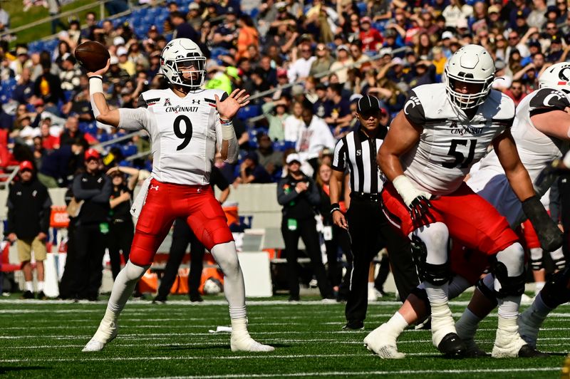 Oct 23, 2021; Annapolis, Maryland, USA;  Cincinnati Bearcats quarterback Desmond Ridder (9) throws from the pocket during the first half against the Navy Midshipmen at Navy-Marine Corps Memorial Stadium. Mandatory Credit: Tommy Gilligan-USA TODAY Sports