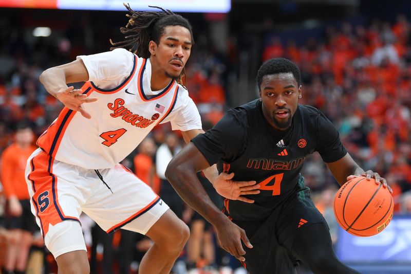 Jan 20, 2024; Syracuse, New York, USA; Miami (Fl) Hurricanes guard Bensley Joseph (4) drives to the basket as Syracuse Orange forward Chris Bell (4) defends during the first half at the JMA Wireless Dome. Mandatory Credit: Rich Barnes-USA TODAY Sports