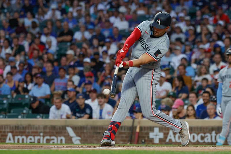 Aug 5, 2024; Chicago, Illinois, USA; Minnesota Twins outfielder Trevor Larnach (9) singles against the Chicago Cubs during the first inning at Wrigley Field. Mandatory Credit: Kamil Krzaczynski-USA TODAY Sports