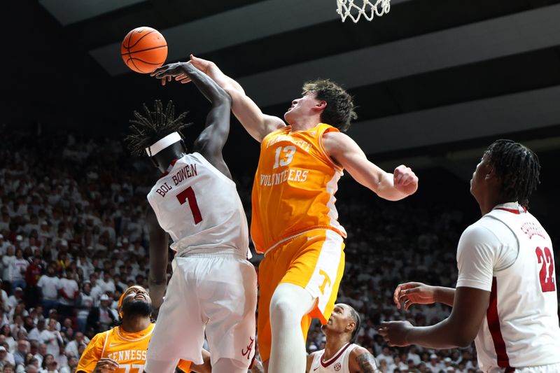 Jan 24, 2026; Tuscaloosa, Alabama, USA; Alabama Crimson Tide forward Taylor Bol Bowen (7) rebounds against Tennessee Volunteers forward J.P. Estrella (13) during the first half at Coleman Coliseum. Mandatory Credit: David Leong-Imagn Images