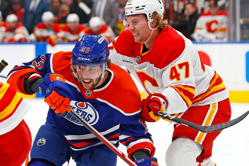 Oct 8, 2025; Edmonton, Alberta, CAN; Edmonton Oilers forward Issac Howard (53) and Calgary Flames forward Connor Zary (47) battle for position during the first period at Rogers Place. Mandatory Credit: Perry Nelson-Imagn Images