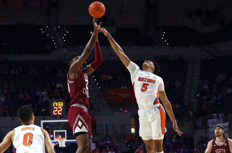 Jan 25, 2023; Gainesville, Florida, USA; South Carolina Gamecocks forward Gregory Jackson II (23) shoots against Florida Gators guard Will Richard (5) during the first half at Exactech Arena at the Stephen C. O'Connell Center. Mandatory Credit: Kim Klement-USA TODAY Sports